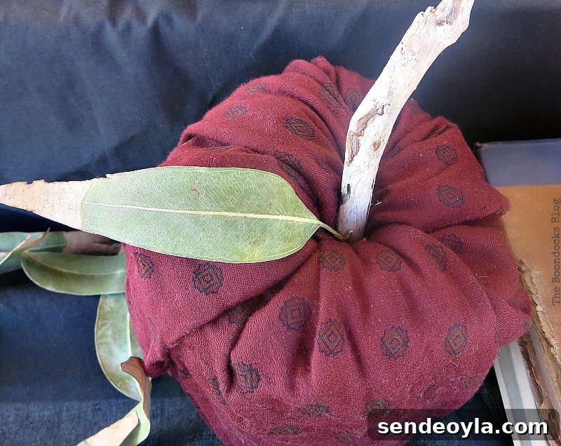 Pumpkin made with scrap fabric, driftwood and dried leaves