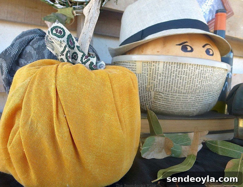 Pumpkin man next to orange and black pumpkins