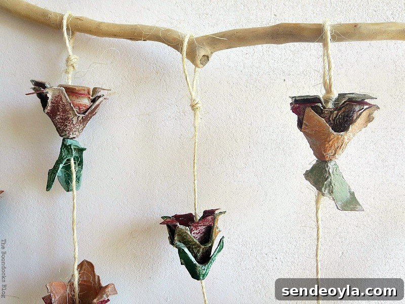 The twine is tied to a piece of wood, How to Make Easy Fall Flowers using Egg Cartons