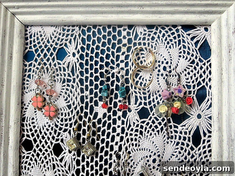 DIY Earring Organizer Ideas to Declutter Your Jewelry 13 Top of the earring organizer showing the rustic frame and earrings.