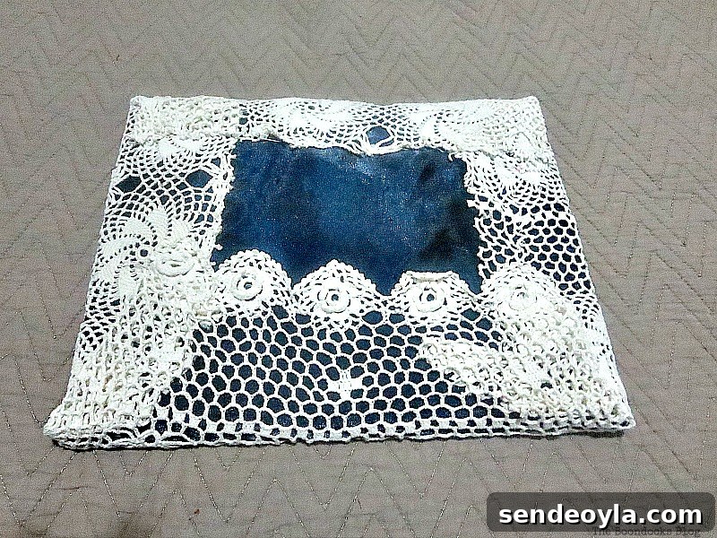 DIY Earring Organizer Ideas to Declutter Your Jewelry 8 The back side of the earring organizer, the blue satin blouse is showing through the doily.