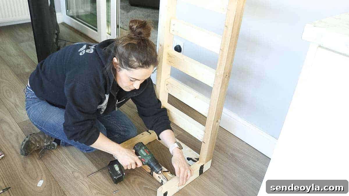 DIY TV Stand from Scrap Wood: Step-by-Step Guide 13 Screwing supports on TV stand legs