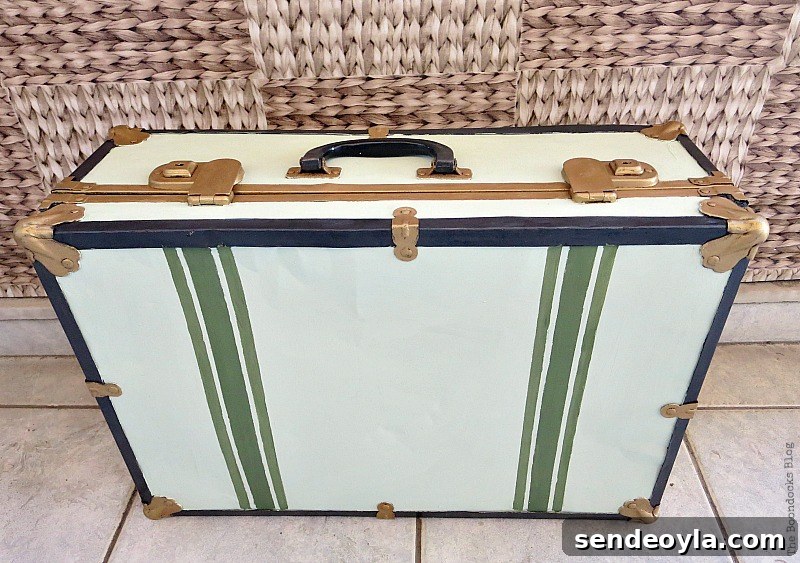 Transform a Vintage Suitcase into Chic Home Storage 11 The finished vintage suitcase after it's been painted white, gold, green and black.