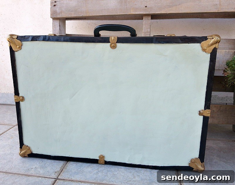 Transform a Vintage Suitcase into Chic Home Storage 14 The bottom of the vintage suitcase, just painted with white paint.