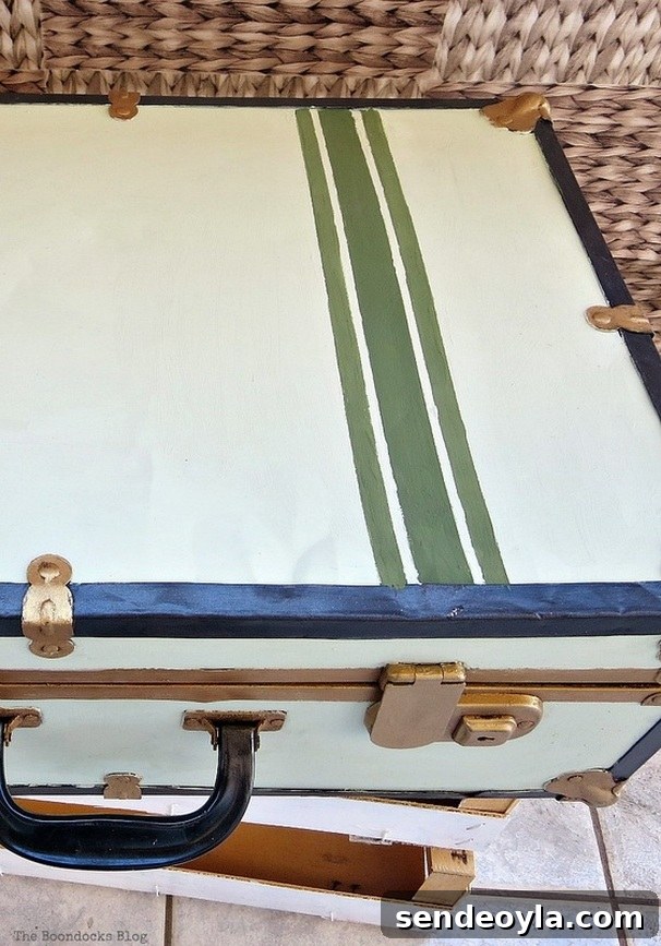 Transform a Vintage Suitcase into Chic Home Storage 17 Close up of the green painted stripes.