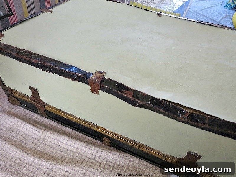 Transform a Vintage Suitcase into Chic Home Storage 4 Painting the sides top and bottom of a vintage suitcase white.