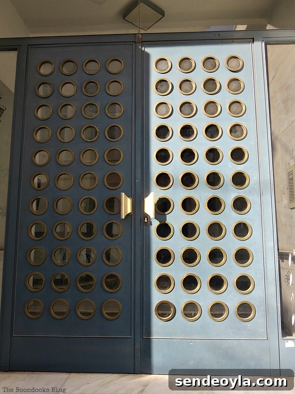 Metal door with circles, Doors and a Sorta Blogoversary