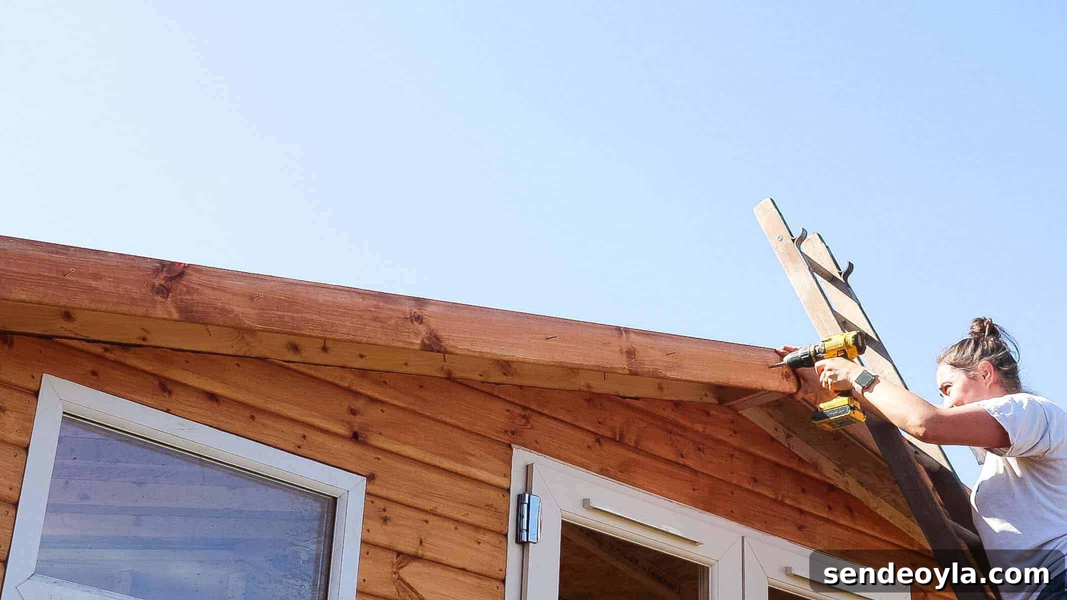 Install Roofing Felt on a Shed: Step-by-Step Tips 17 Apprentice woman carpenter screwing roof felt trim to shed