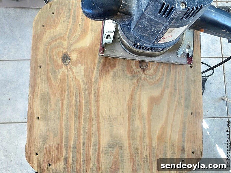 Milk Crate Table Upcycle: Stylish DIY Makeover 6 Sanding the plywood top of the table.