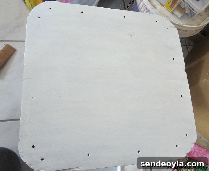 Milk Crate Table Upcycle: Stylish DIY Makeover 7 Painting the plywood top white.