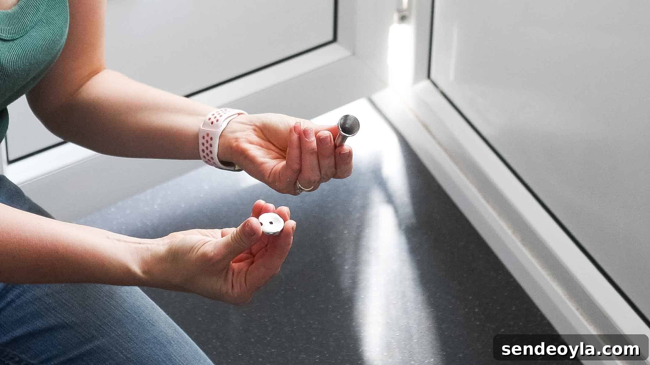 diy blogger showing door stopper in parts for screw hole