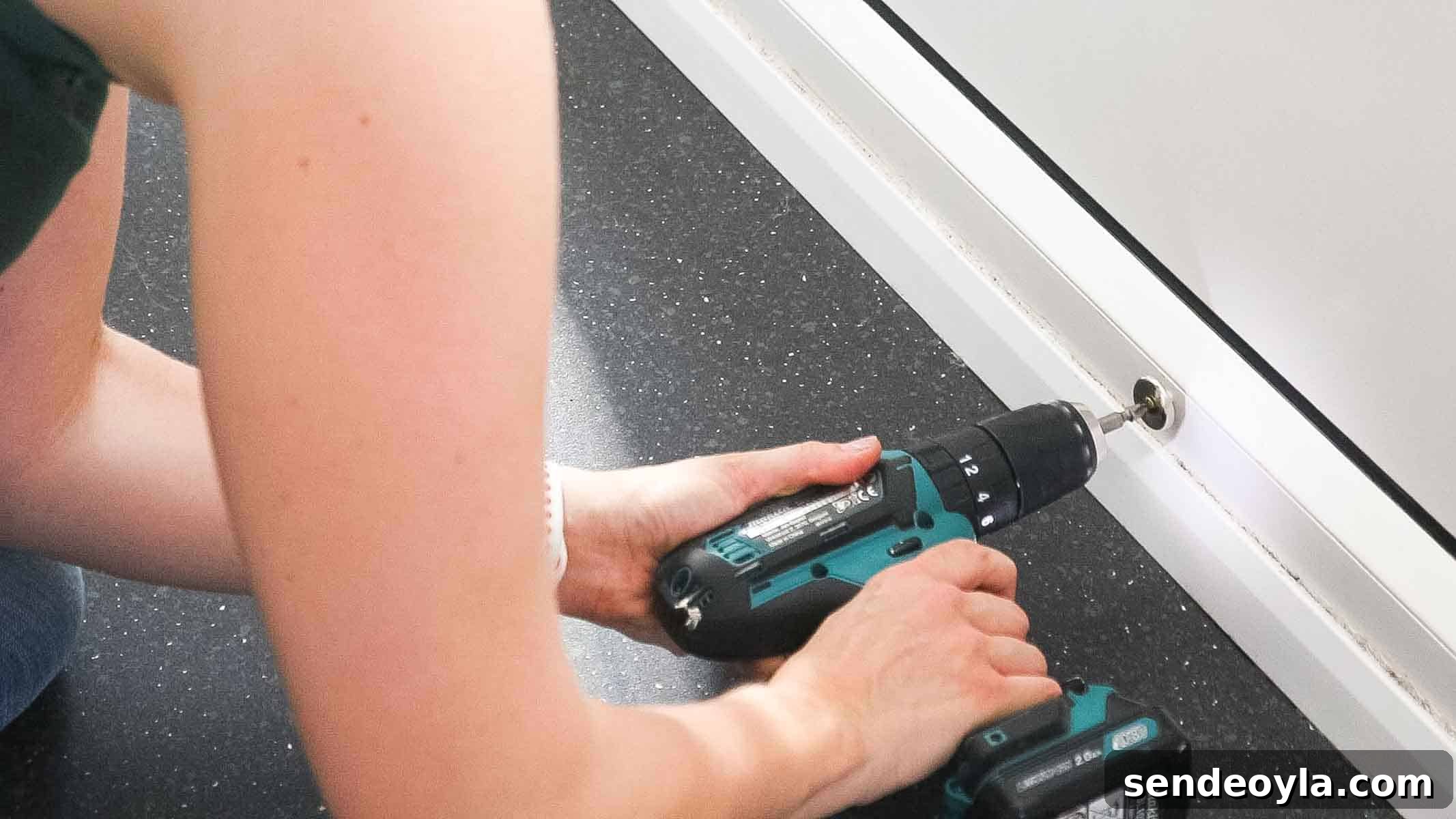 screwing on mounting plate of door stop to skirting