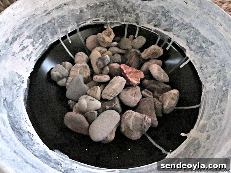 rocks for drainage in a planter made from a grill, Grilling the plants for Earth Day www.theboondocksblog.com