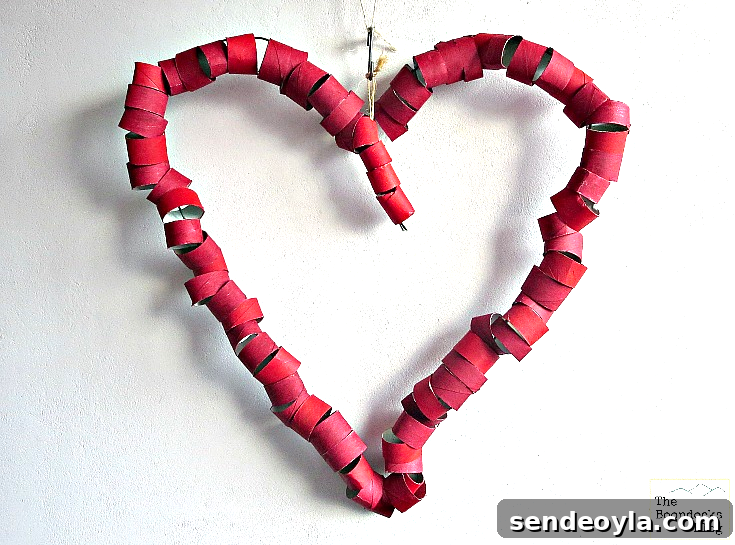 DIY Heart Wreath from Toilet Paper Rolls 5 Heart shaped wire covered with toilet paper roll sections painted red.