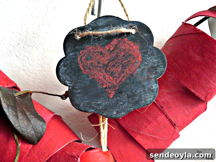DIY Heart Wreath from Toilet Paper Rolls 6 A mini-chalkboard sign added to the top of the heart wreath.