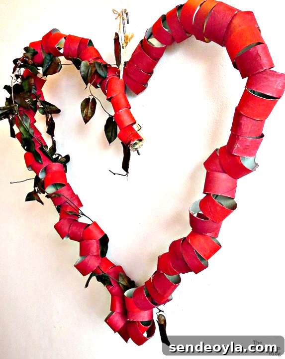 DIY Heart Wreath from Toilet Paper Rolls 9 The finished heart-shaped wreath hanging on the wall.