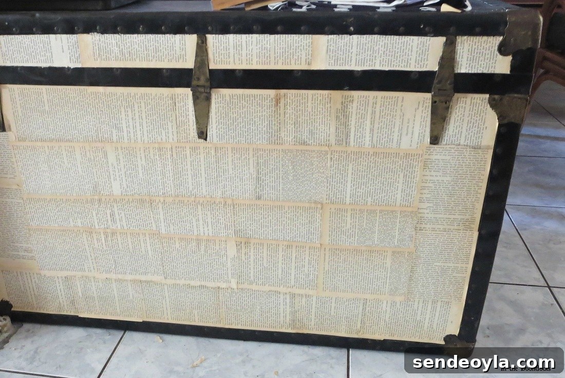 DIY Metal Trunk Makeover with Vintage Book Pages 6 Old Trunk covered in book pages The chivalrous Trunk www.theboondocksblog.com