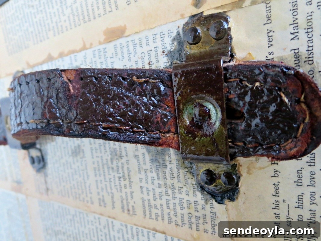 DIY Metal Trunk Makeover with Vintage Book Pages 10 Detail of Old Trunk Covered in Book pages leather handle, The chivalrous Trunk www.theboondocksblog.com